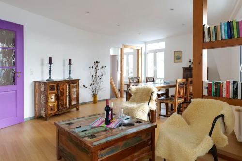a living room with two chairs and a table at Goldener Löwe in Bodman-Ludwigshafen
