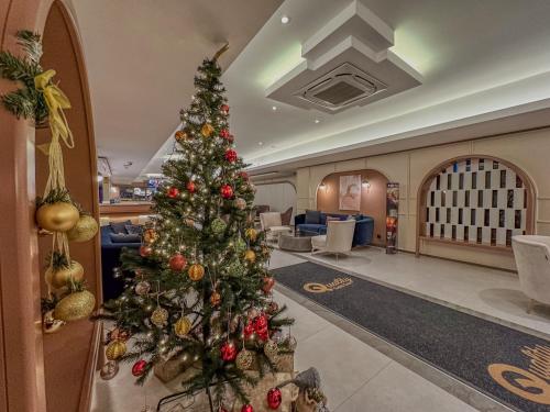 a christmas tree in the lobby of a hotel at Quality Gold Suite Hotel in Antalya