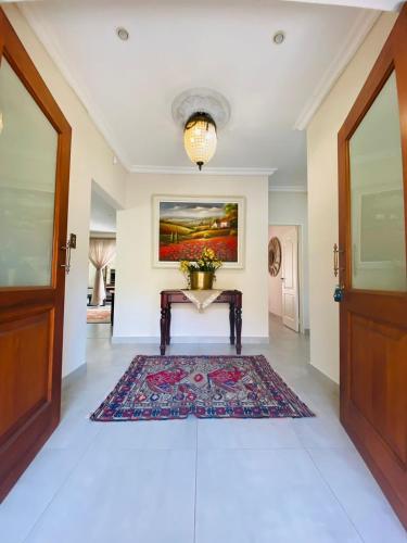 a hallway with a table and a rug at Blissful Bracelet in Nelspruit