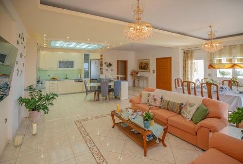 a living room with a couch and a table at Apple home Detached house in sunny Ierapetra in Ierapetra