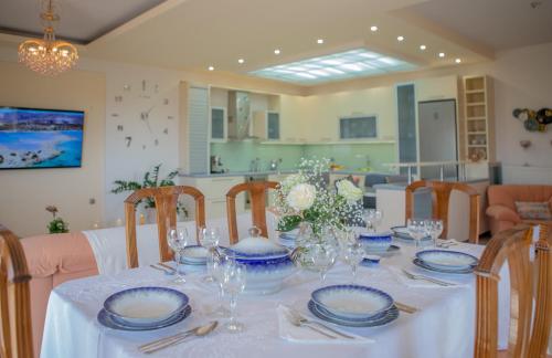 a dining room table with blue and white dishes on it at Apple home Detached house in sunny Ierapetra in Ierápetra