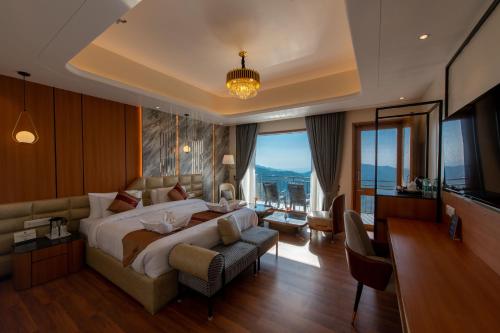 a bedroom with a large bed and a living room at Ekant Retreat Resort in Chail