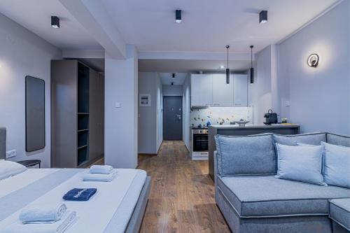 a room with a bed and a couch and a kitchen at Luxury Downtown Apartment Α2 in Thessaloniki
