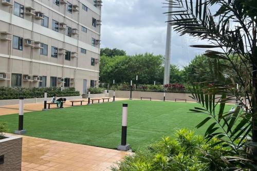 a park with benches in front of a building at Cavite Budget Airbnb with Resort-like Amenities in Dasmariñas