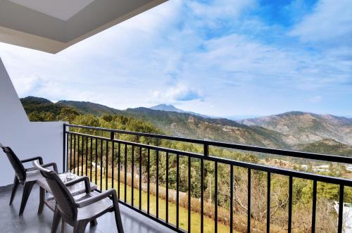 a balcony with chairs and a view of mountains at Ekant Retreat Resort in Chail
