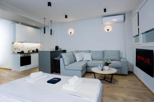 a living room with a couch and a table at Luxury Downtown Apartment Α2 in Thessaloniki