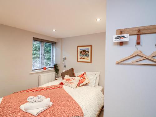 a bedroom with a bed with towels on it at 2 Russell Court in Salcombe