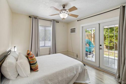 a bedroom with a bed and a ceiling fan at Beach Bungalows By The Sea 3 in Cocoa Beach