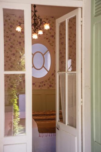 une porte menant à une pièce ornée de fleurs sur le mur. dans l'établissement La Petite Calanque, à Marseille