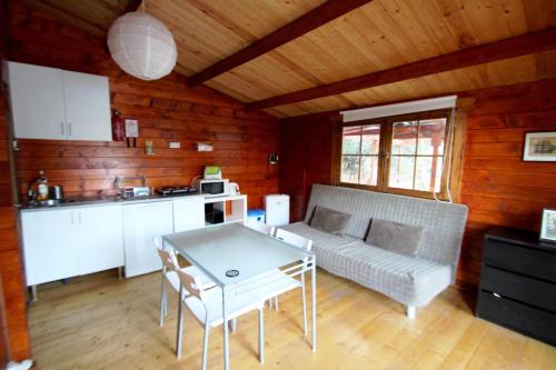 a living room with a couch and a table at Douro Yacht Charter & Bungalows in São João da Pesqueira