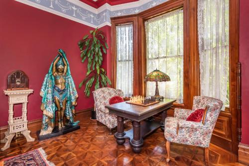 a room with a table and chairs and a statue at Chateau Tivoli Bed and Breakfast in San Francisco