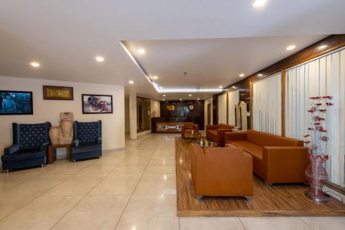 a lobby with couches and chairs in a building at Ekant Retreat Resort in Chail