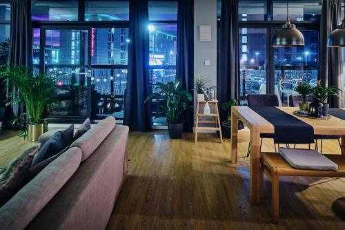 a living room with a couch and a table at Glasgow, Finnieston Luxury 2 Bed with parking, e-check in, hi-fi in Glasgow