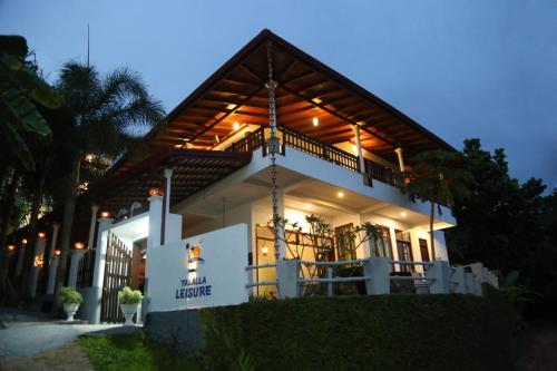 a house with a lit up facade at night at Talalla Leisure in Talalla