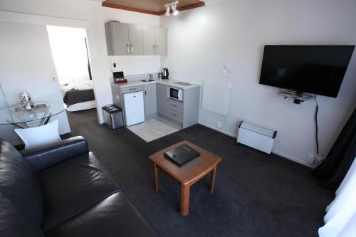 a living room with a couch and a coffee table at Aspen on King in Timaru