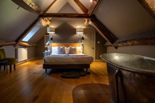 a bedroom with a bed in a attic at The Archangel,Restaurant & Bar with Rooms in Frome