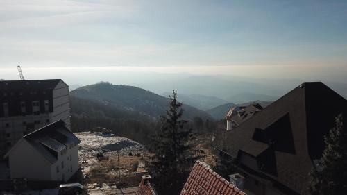 a view of a city with mountains in the background at Vila Milica Apartmani in Kopaonik