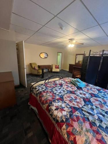 a bedroom with a bed with a quilt on it at Spacious Apt near Guthrie Packer in Sayre