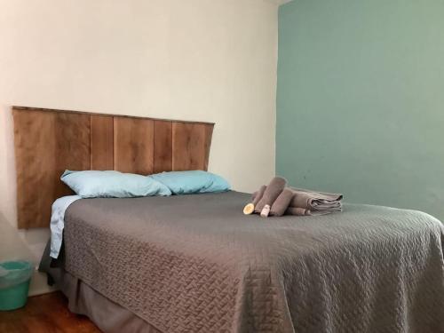 a bed with a teddy bear sitting on top of it at Spacious Inviting Home by BU UHS & Guthrie in Johnson City