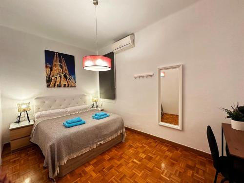 a bedroom with a bed and a painting of the eiffel tower at Rooms Nuevo Roger in Barcelona