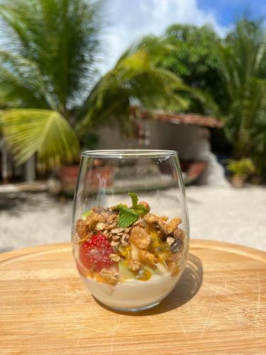 a glass bowl filled with food on a table at Pousada Minha Praia in João Pessoa