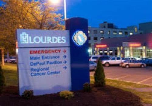 a sign in front of a parking lot with cars at Spacious 3 bed by Wilson, Lourdes Hospitals near Vestal in Johnson City