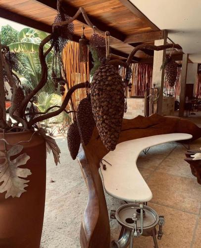 a salon with a chair and a pineapple hanging from a ceiling at Pousada Minha Praia in João Pessoa