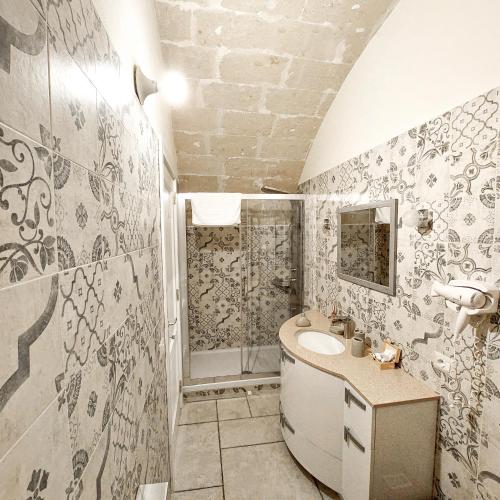 a bathroom with a sink and a shower at Mikasa in Matera
