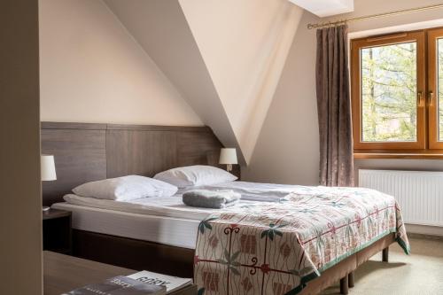 a bedroom with a bed and a window at Dom Wczasowy Grań in Zakopane