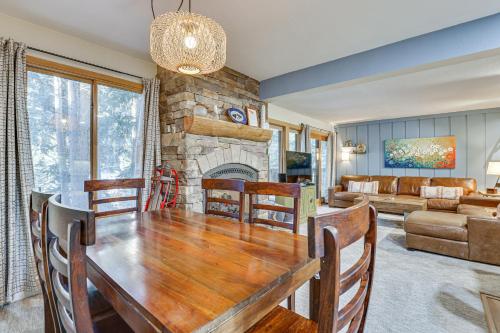 a dining room with a table and a fireplace at Walk to Lifts! SnowDogs Breck Condo with Fireplace in Breckenridge