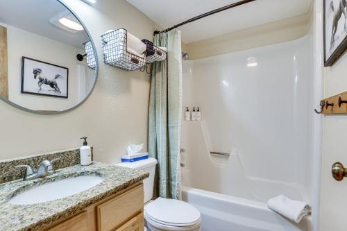 a bathroom with a sink and a toilet and a mirror at SnowDogs Breck Condo with Fireplace Walk to Lifts in Breckenridge