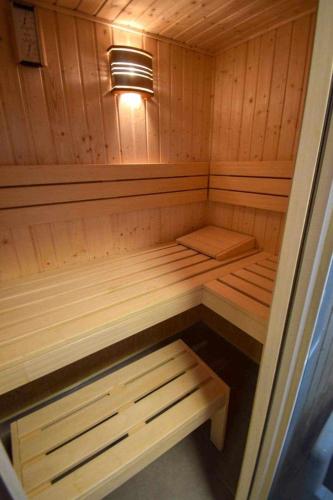 a small wooden sauna with a light in it at Villa6 in Pobierowo