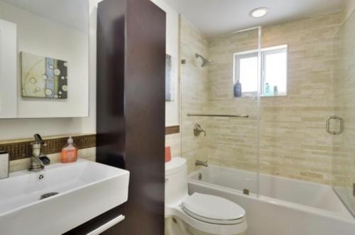 Un baño con inodoro, lavabo y ducha. en West Plaza Del Lago, en Islamorada