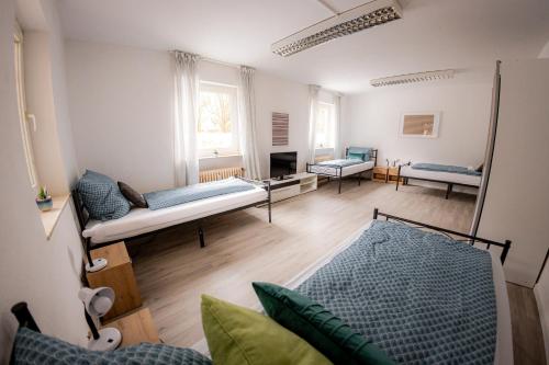 a living room with a bed and a couch at Am Waldrand nähe Nürnberg Messe in Schwarzenbruck