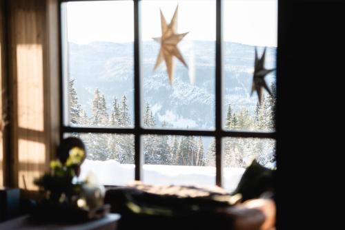 a view of a snowy mountain through a window at Ski inn-ski ut hytte i Aurdal - helt ny in Aurdal