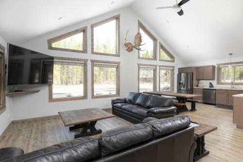 a living room with a couch and a table at The Antler Ridge Cabin in Valemount