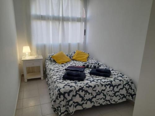 a bedroom with a bed with two pillows on it at amarilla terrace in Arona