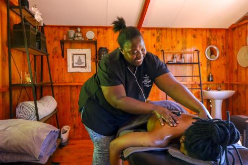 a woman getting her hair cut by a woman at Barefoot Addo Elephant Lodge in Addo