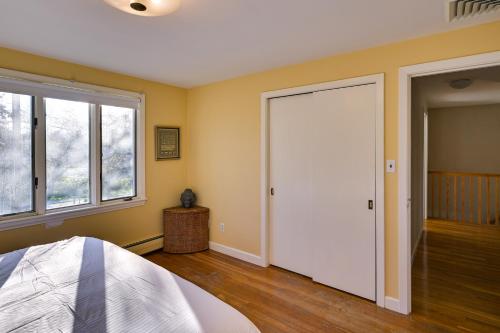 a bedroom with a white door and a window at Pet-Friendly Marblehead Home Near Preston Beach! in Marblehead