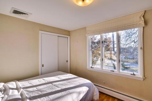 a bedroom with a bed and a window at Pet-Friendly Marblehead Home Near Preston Beach! in Marblehead
