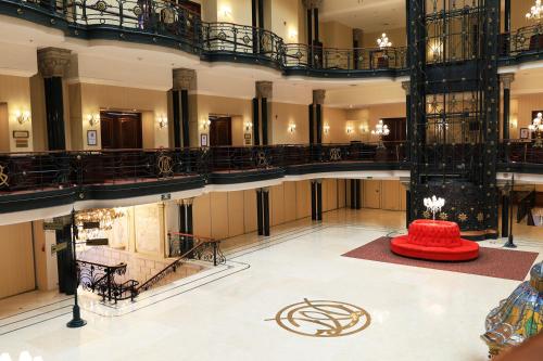 a large lobby with a red table in the middle at Gran Hotel Ciudad de México Zócalo View in Mexico City