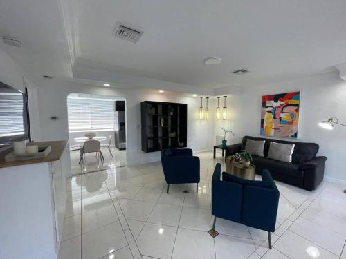 a living room with a couch and a table at Stylish Home close to everything in Hollywood