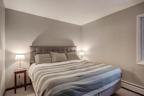 a bedroom with a large bed and two lamps at Modern with Hot Tub & Pool by Ski Country Resorts in Frisco