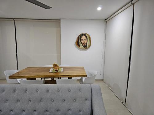 a dining room with a table and a couch at Yellow beach & rest II in Coveñas