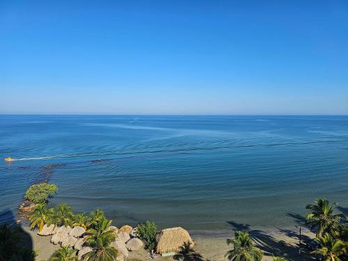an aerial view of the ocean with palm trees at Yellow beach & rest II in Coveñas