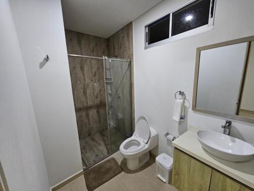 a bathroom with a shower and a toilet and a sink at Yellow beach & rest II in Coveñas
