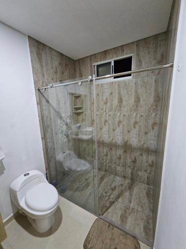 a bathroom with a shower and a toilet at Yellow beach & rest II in Coveñas