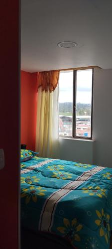 a bedroom with a bed and a window at Ipiales Puerta de Oro Alborada in Ipiales