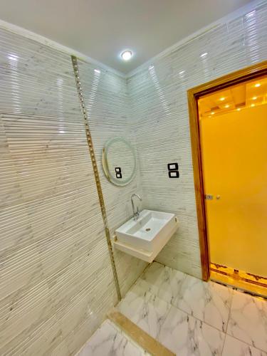 a bathroom with a sink and a mirror at Enjoy pyramids Golden Hotel in Cairo