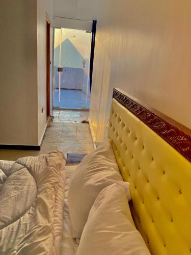 a large bed in a room with a doorway at Enjoy pyramids Golden Hotel in Cairo